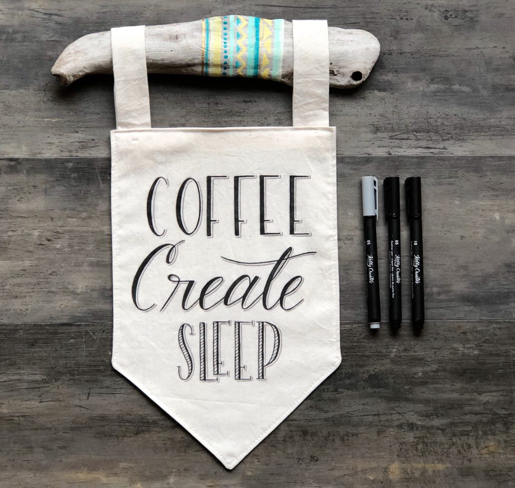 Learn how to make this adorable coffee theme fabric banner with hand lettering and pens with Bonnie Peters on www.kellycreates.ca